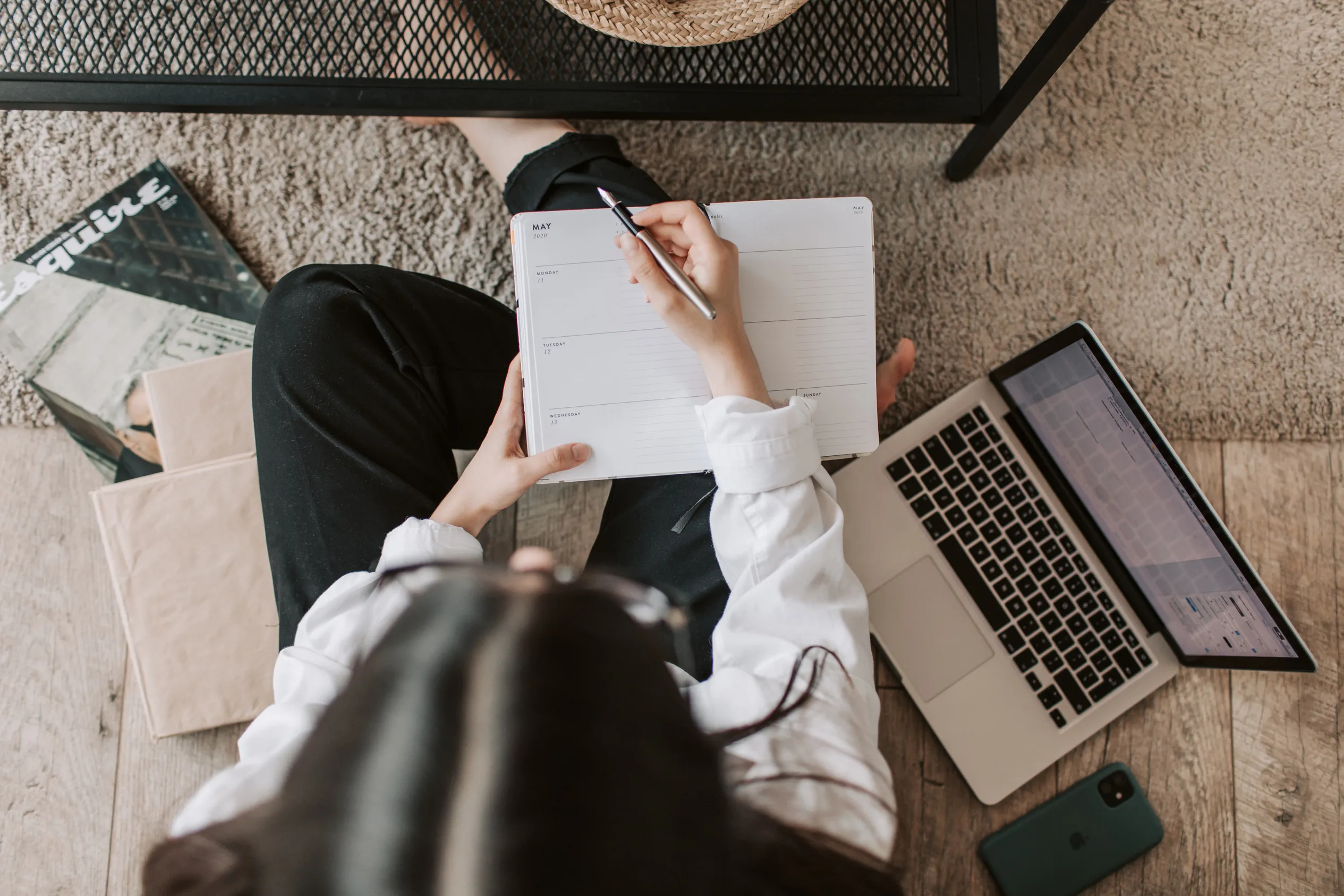 Overhead view of a planner and laptop, mapping out next steps